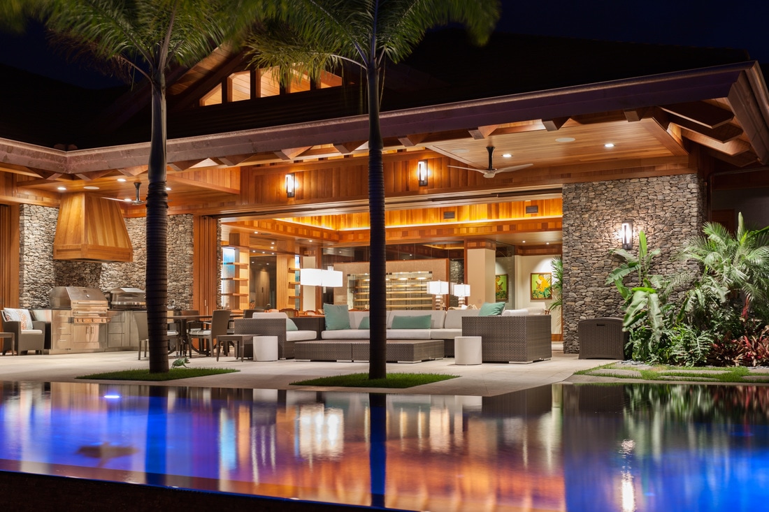 A luxury pool home at night.